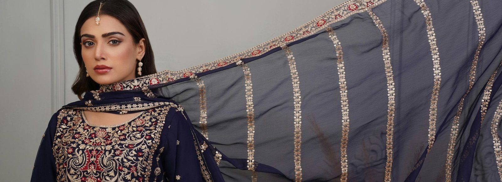 Navy embroidered ethnic outfit with a gold-trimmed dupatta
